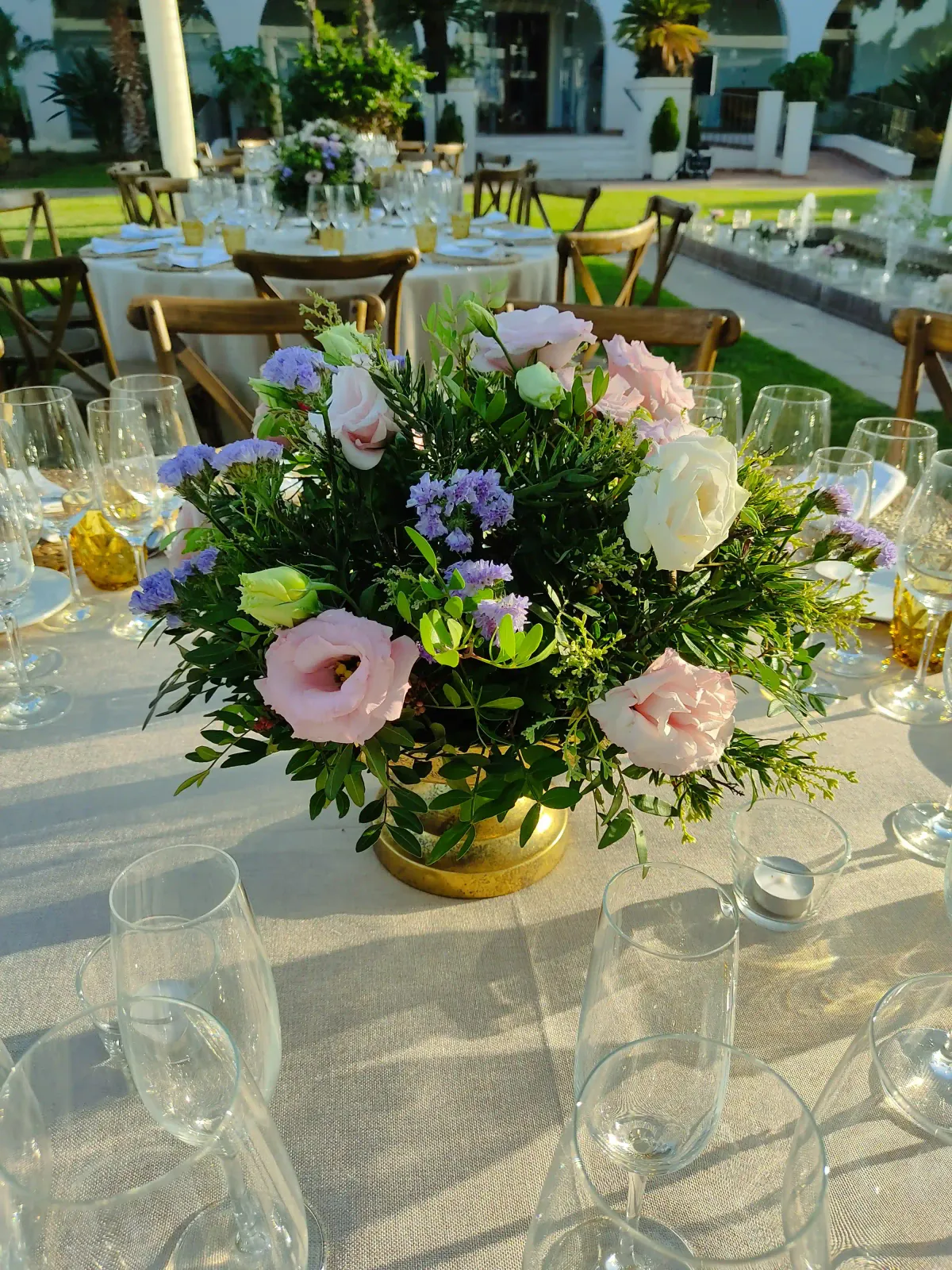 A hand-tied bouquet of garden roses and ranunculus in soft blush tones